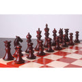 Bud rosewood Staunton chess pieces displayed on a wooden board.
