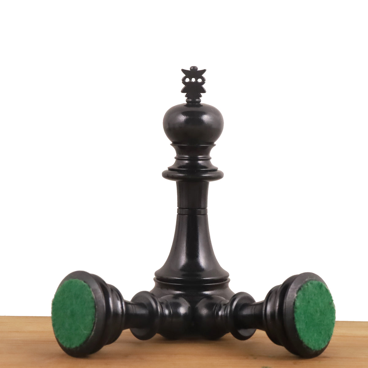 Triple-weighted ebony chess pieces featuring protective green felt bases.