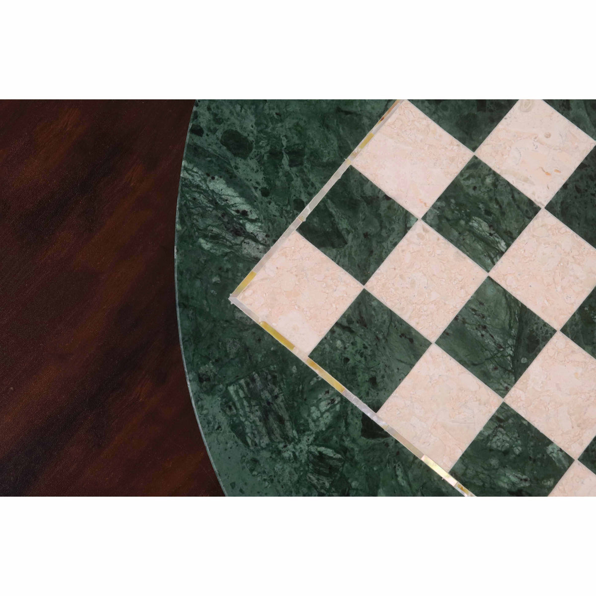 Detailed close-up of the hand-inlaid white semi-precious stone and green marble squares on a luxury round chess board.
