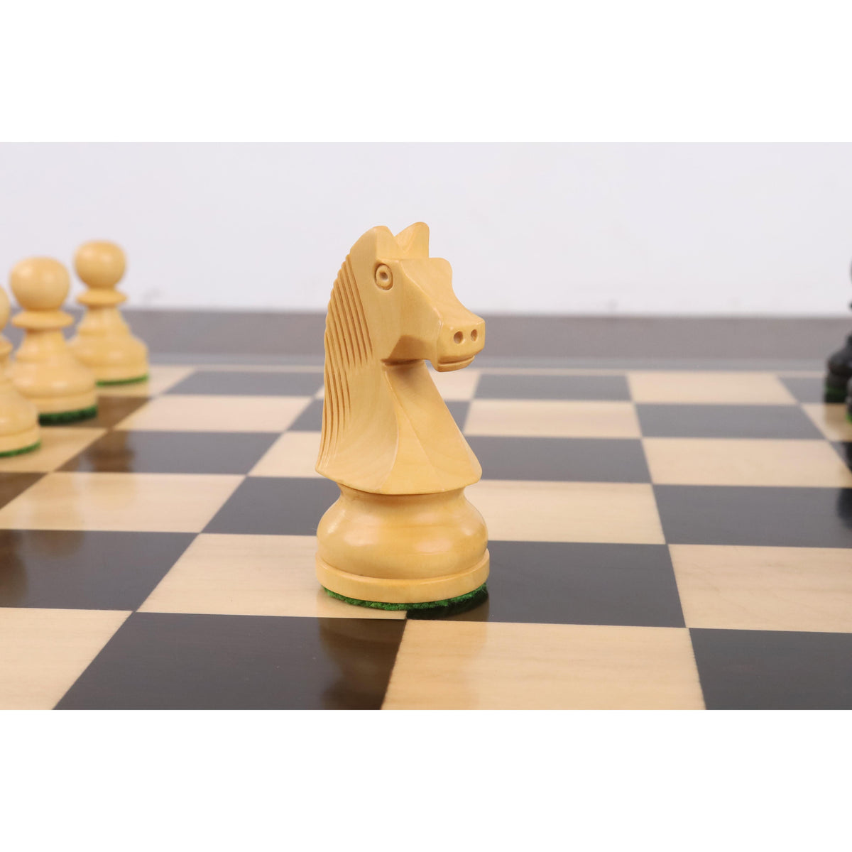 Profile view of a white boxwood knight from the 3.3" Tournament Staunton chess pieces collection.