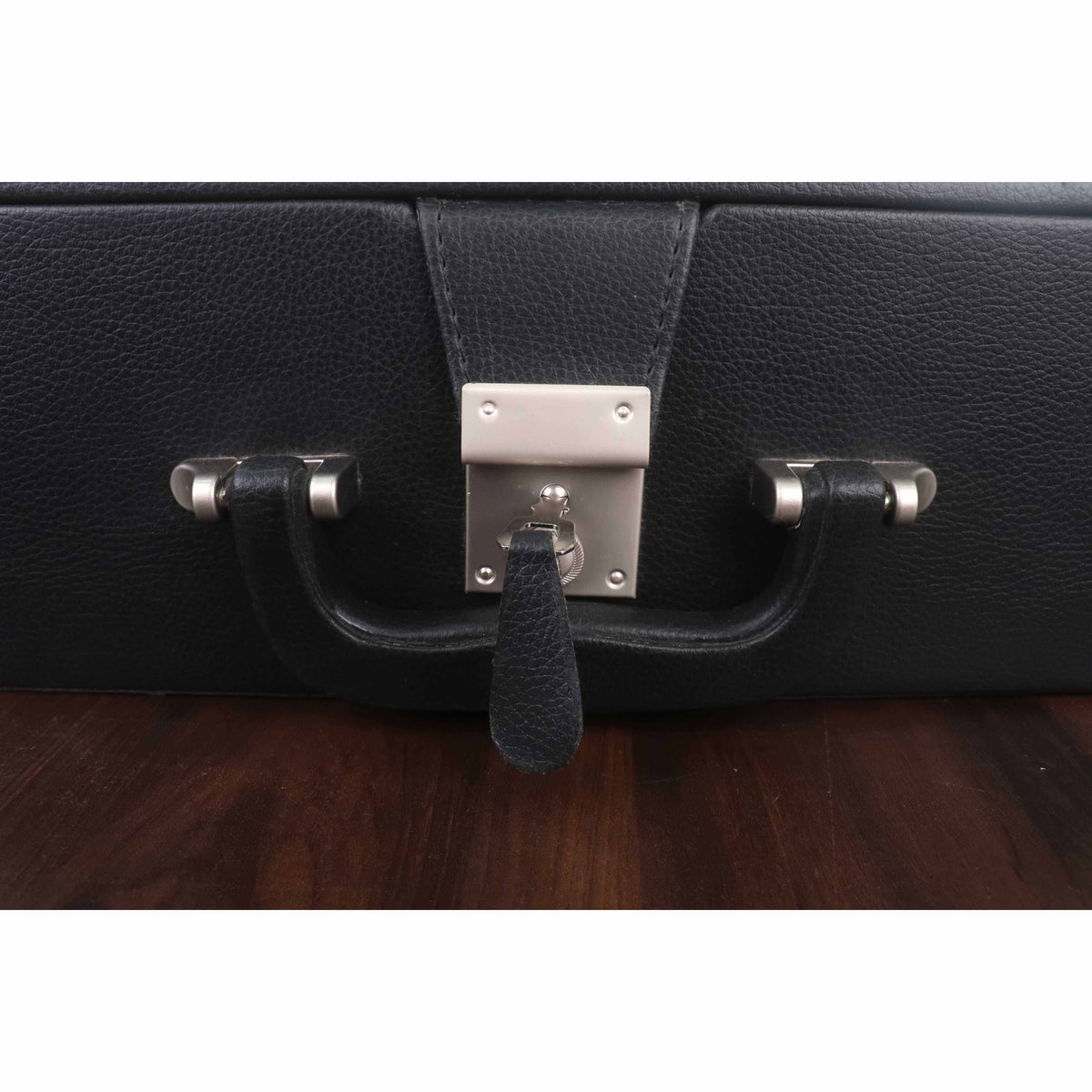 Detailed view of the polished metal lock and handle on a luxury black leatherette chess storage case.
