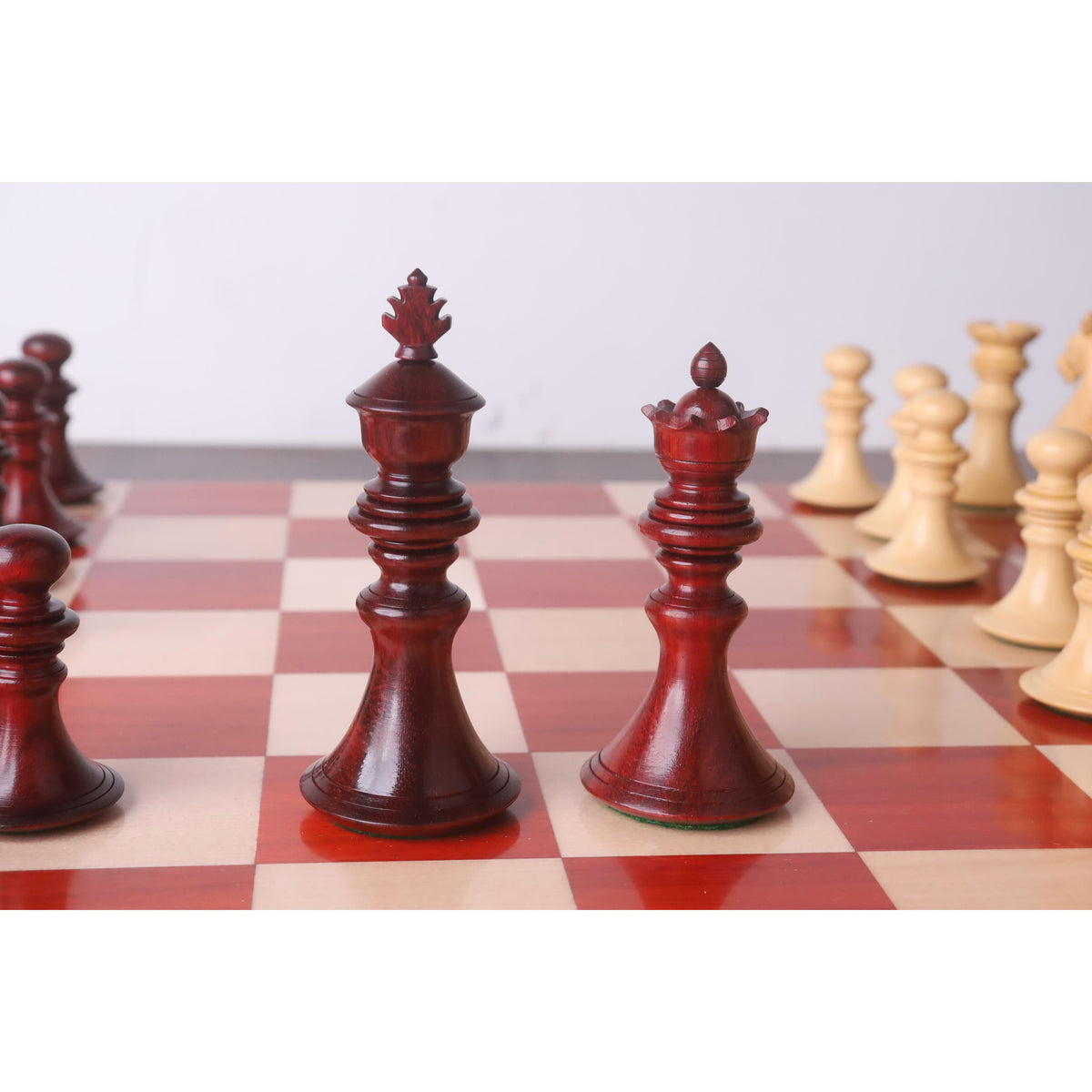 Hand-carved bud rosewood king and queen Staunton chess pieces.