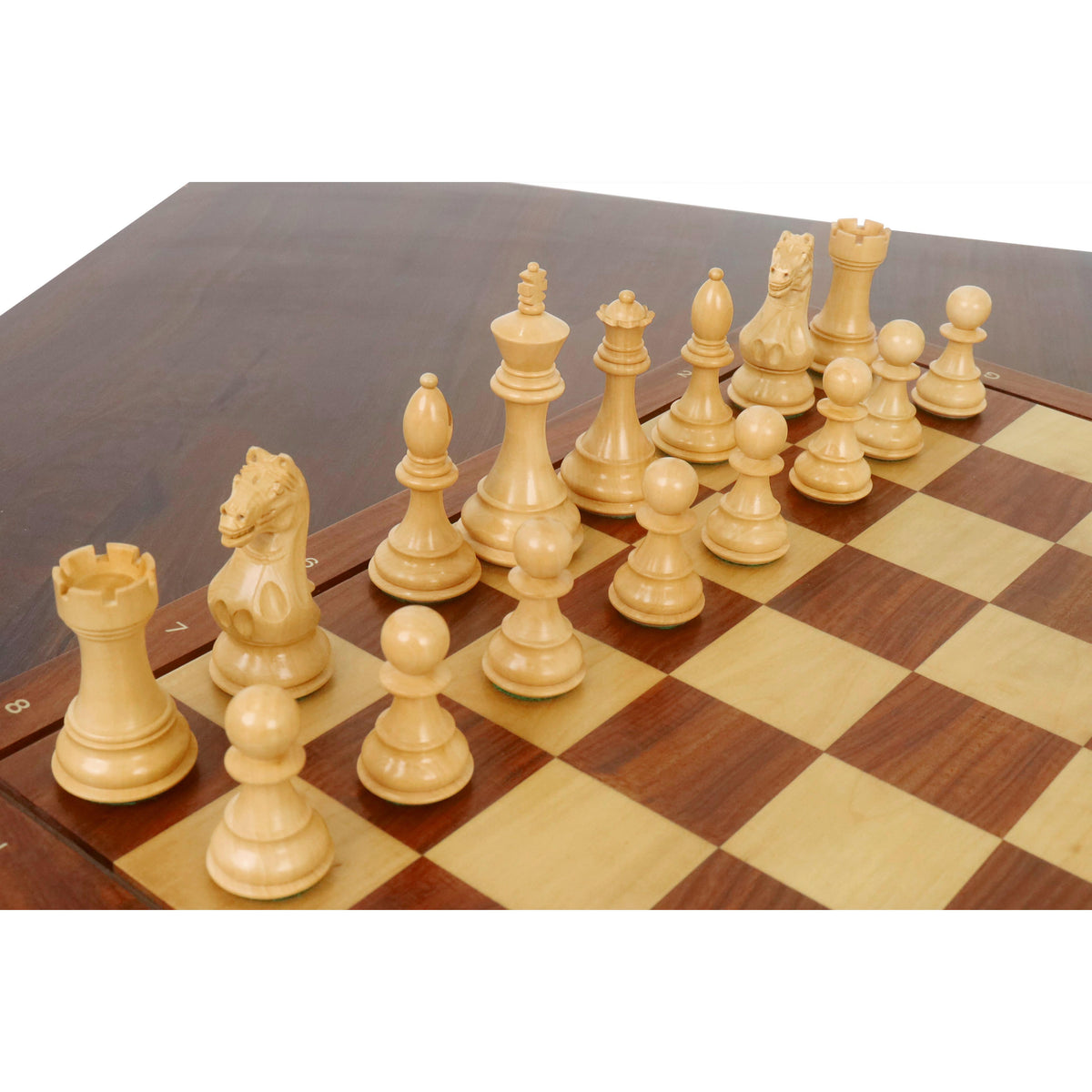 Complete side of boxwood Fierce Knight Staunton chess pieces lined up on a chessboard.