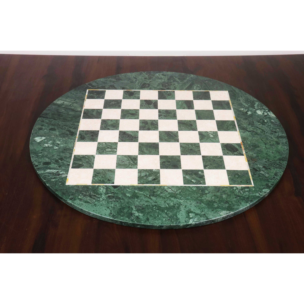 Wide-angle perspective of the 24-inch luxurious green marble round chess board displayed on a wooden table, emphasizing its large scale and premium aesthetic.