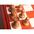 Overhead view of light antiqued boxwood rook, knight, and pawn chess pieces on board.