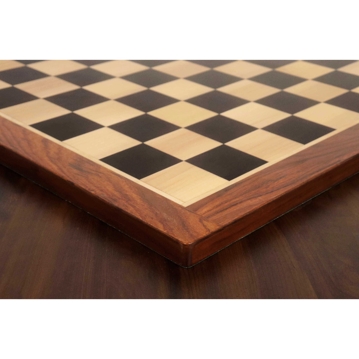 Detailed perspective view of the mitered Golden Rosewood border on a large Ebony and Maple tournament chess board.