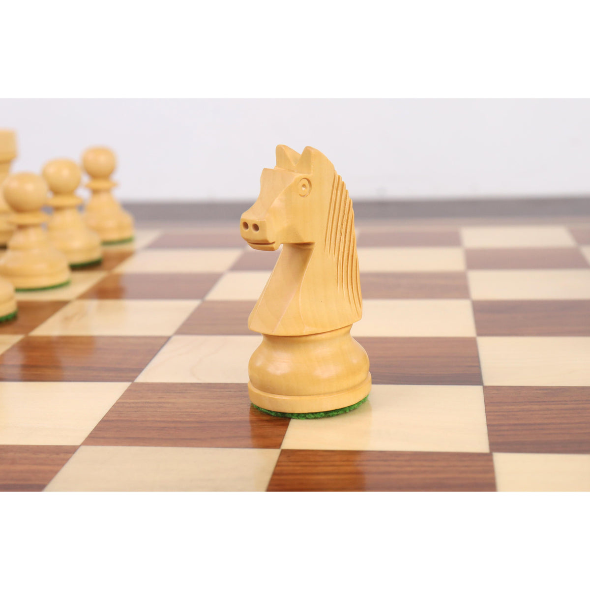 A profile close-up of the Boxwood Staunton chess knight, highlighting the intricate carving of its face and mane.