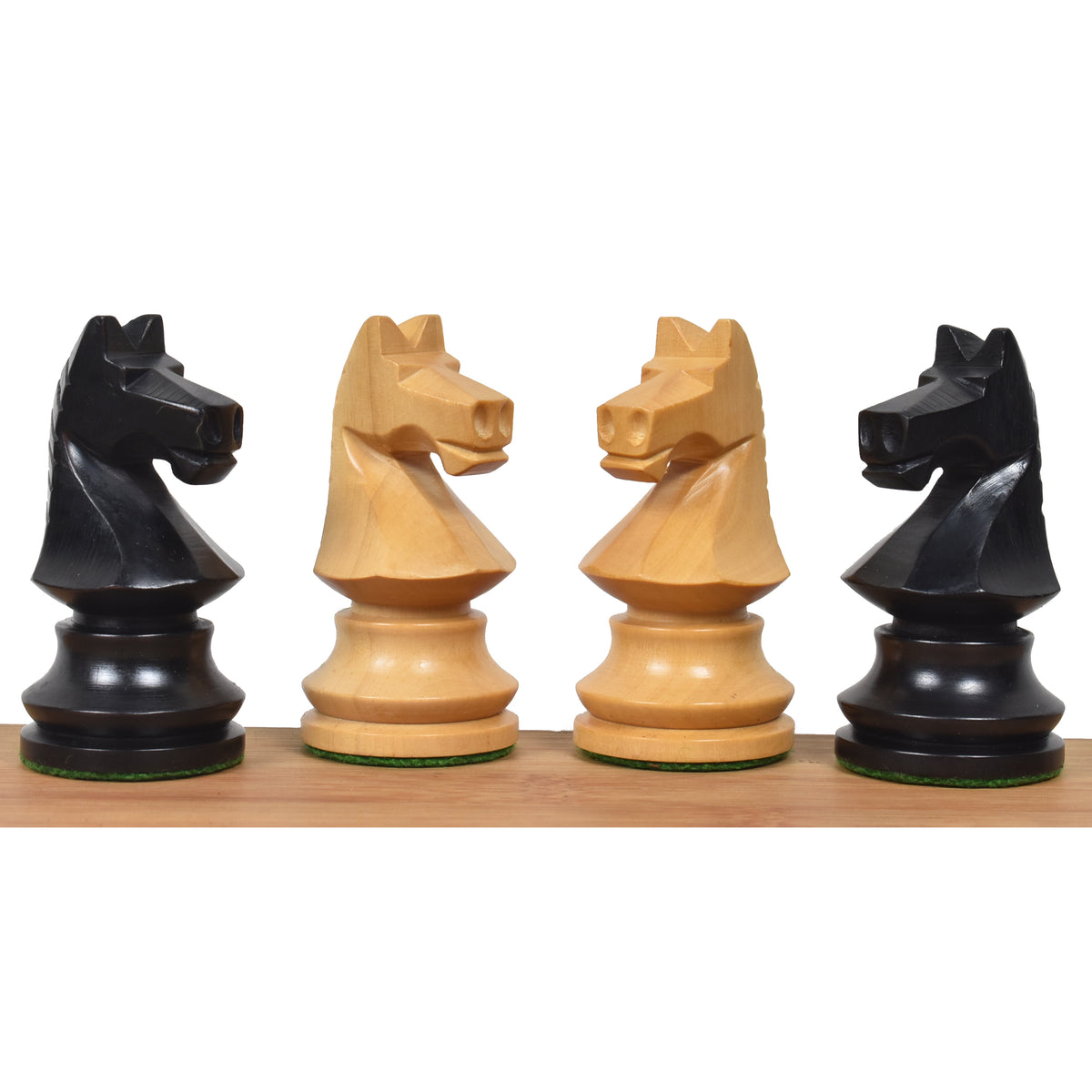 Detailed close-up of distinctively carved Romanian Hungarian chess knights in dark ebonised and natural wood finishes.