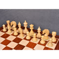 An elevated view of the Bud Rosewood Dragon chess pieces set up on a 23-inch wooden chessboard.