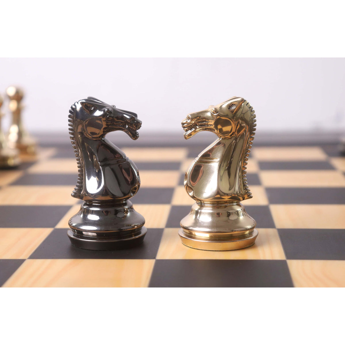 Detailed view of metallic gold and grey chess knights.