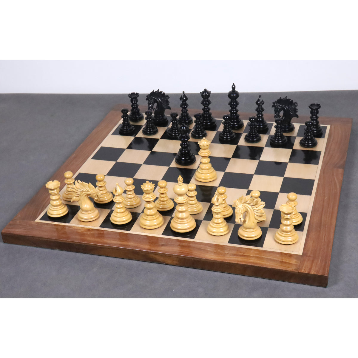 Complete Marengo luxury Staunton chess pieces set set up on a premium wood board in a full game layout.