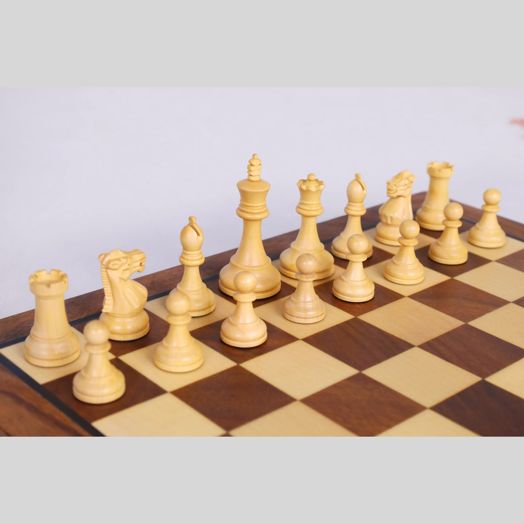 White boxwood chess pieces arranged neatly on the maple wood squares of the travel board.