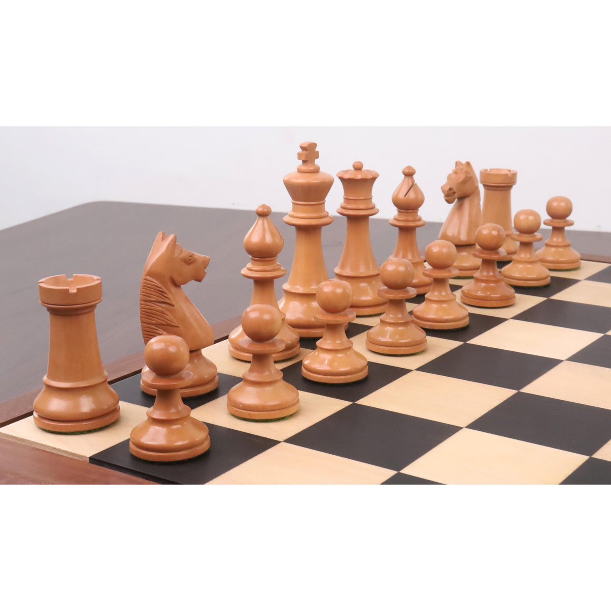 Perspective view of antiqued boxwood 1950s Soviet Grandmaster chess pieces on the board.