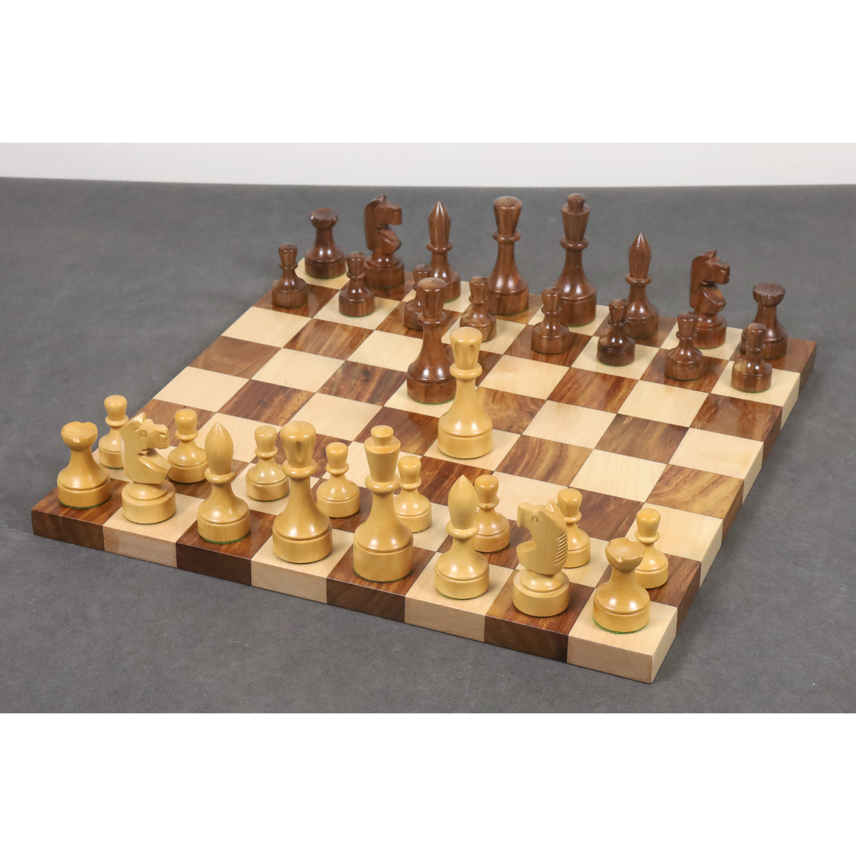 Complete 3.8" Bundesform German Staunton chess set arranged on a board against a grey background.