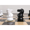 White and black Pro Staunton knight chess pieces facing each other on a 17 inch ebony and maple board.