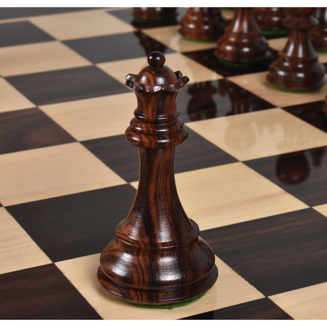 Weighted rosewood queen chess piece displayed on a polished wooden chess board.