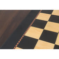 Macro view of the 55mm ebony and maple squares on the Queens Gambit printed chess board.