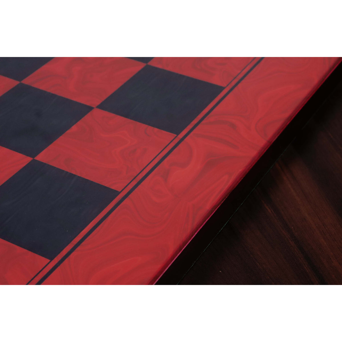 Close-up of the elegant black border inlay and red burl grain on a professional 22 inch chess board.
