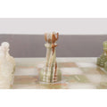 Detailed green onyx marble rook chess piece on the stone board.