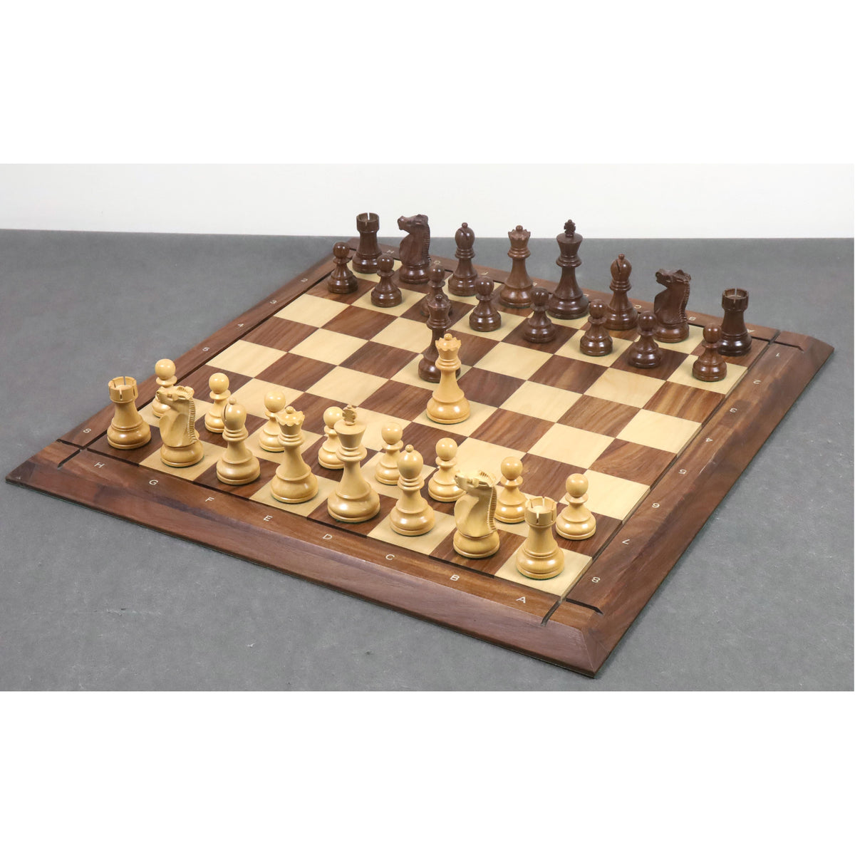 Full set of 1972 World Chess Championship commemorative pieces arranged on a professional wooden chess board.