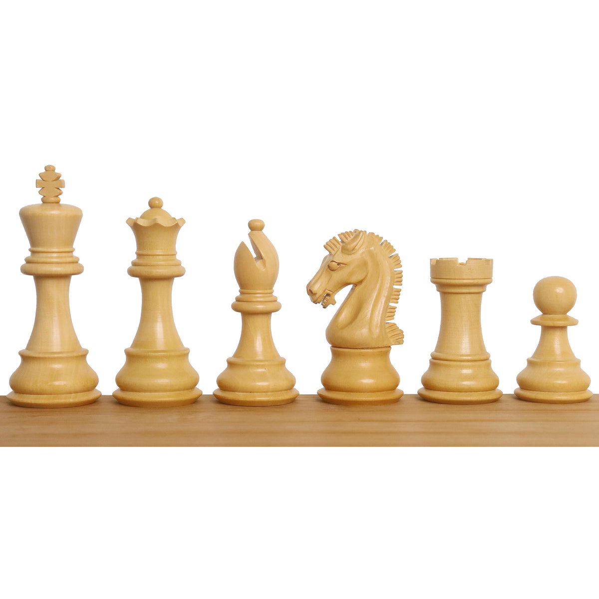 Complete lineup of natural boxwood Craftsman Staunton chess pieces showing detailed hand-carving.
