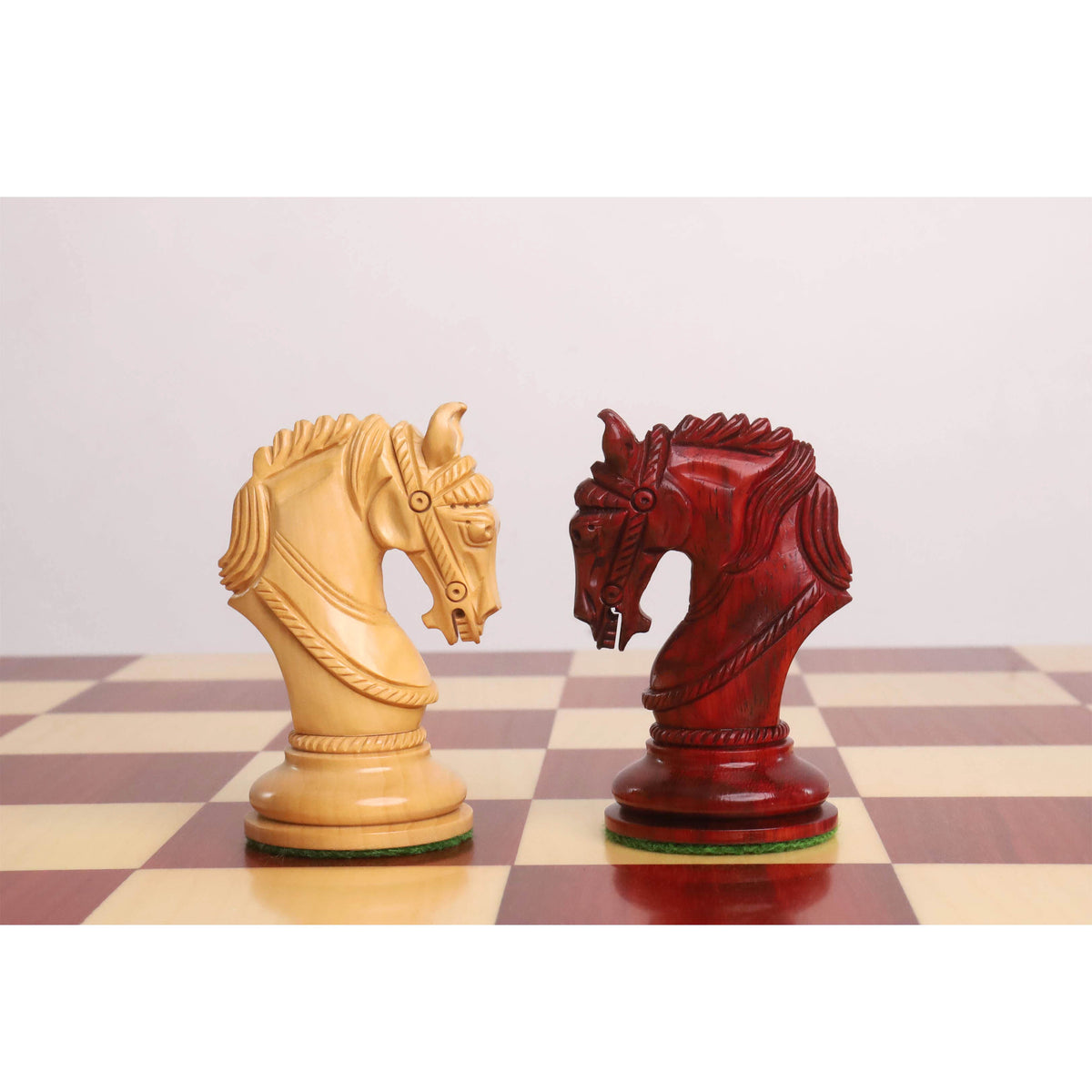 Contrasting boxwood and bud rosewood knight pieces from the Imperator set.