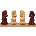 A profile lineup of four intricately carved Napoleon Luxury Staunton knights in Bud Rosewood and Boxwood on a wooden surface.
