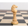 Intricately carved boxwood knight piece from the Edinburgh upright pre-Staunton chess set on a board.