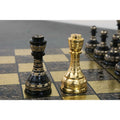 Steel grey and gold Soviet brass metal luxury chess queens close-up.