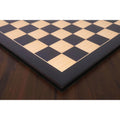 High-contrast corner detail of a 26 inch large ebony and maple wood printed chess board.