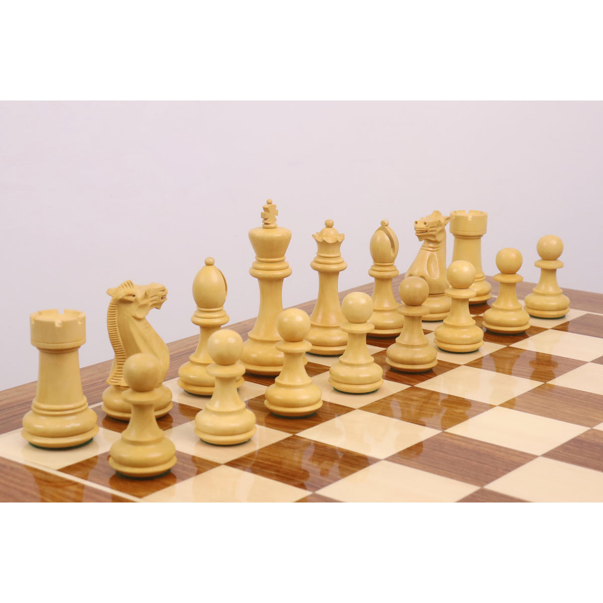A full rank of Boxwood Pro Staunton weighted chess pieces set against the high-gloss tournament chess board.