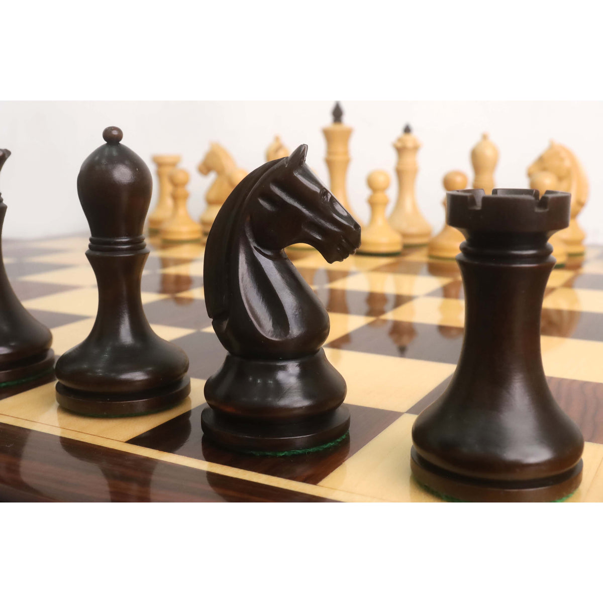 Close-up of the mahogany stained boxwood Knight and Rook from the 3.8" Candidates Series Minimalist chess set.