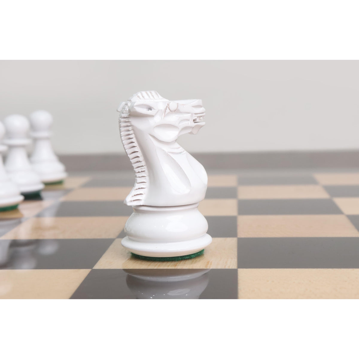 Intricate carving details of a white Pro Staunton knight chess piece from the wooden combo set.