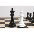 Black King and white Queen texture painted Staunton chess pieces standing together on a wooden chessboard.