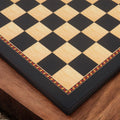 High-angle corner shot of the Queen's Gambit chess board showcasing the 55mm square size and matte surface.