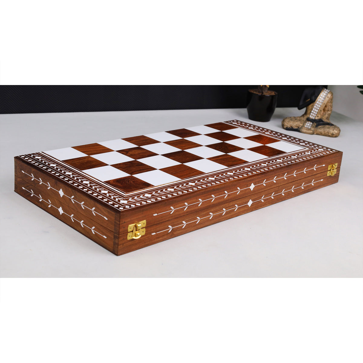 Closed golden rosewood folding chess board with acrylic ivory inlay.