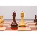 Close-up of a Bud Rosewood knight and rook from the Spiraled Steed luxury chess set on a board.