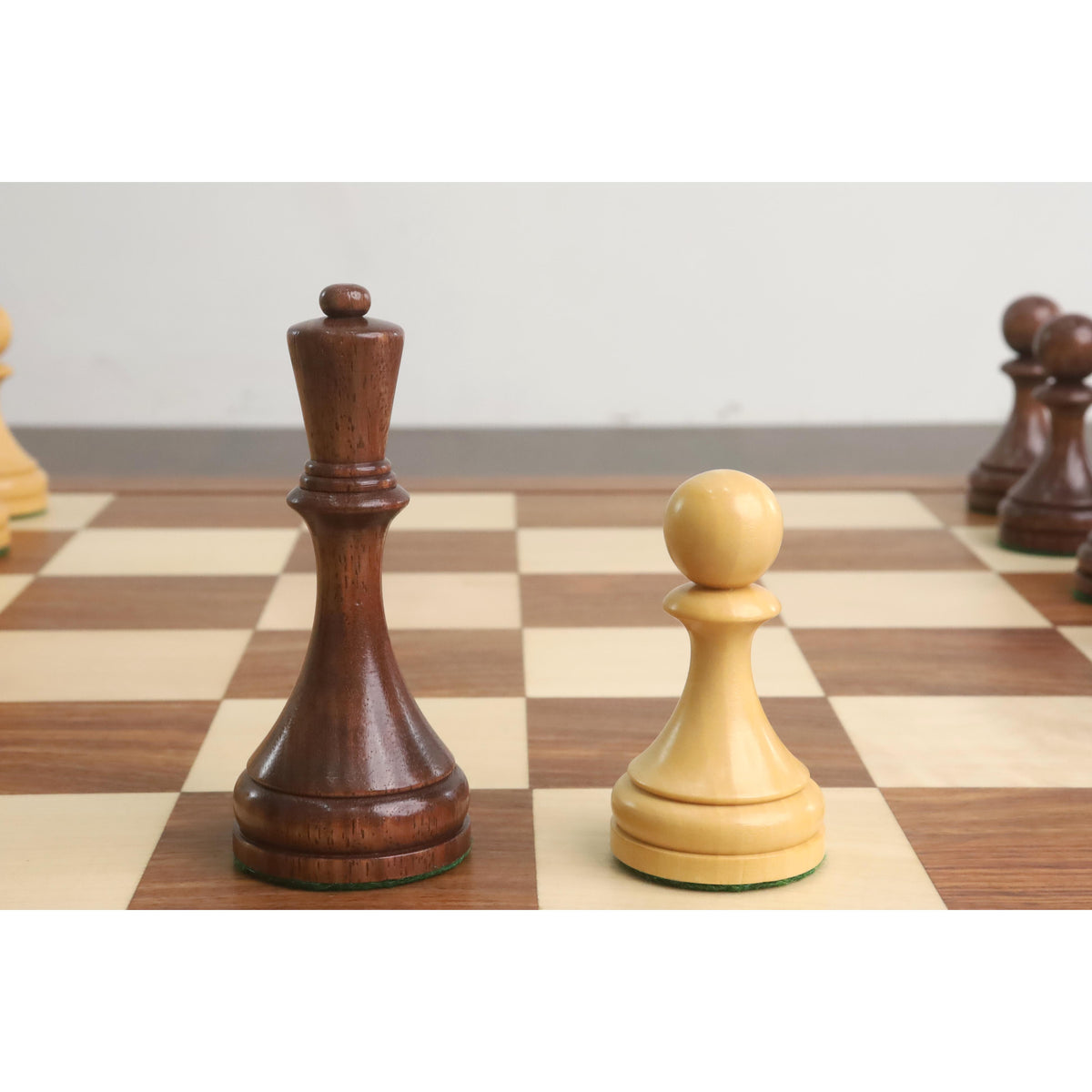 Close-up of the elegant Soviet queen and pawn pieces on the board.