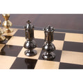 Metallic grey Victorian King and Queen pieces placed on a chessboard.