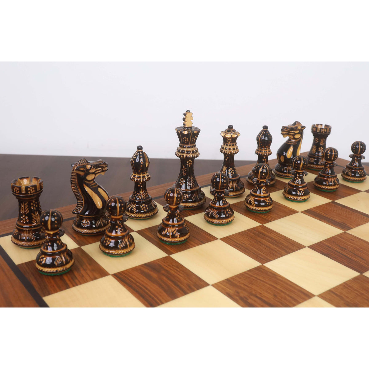 Professional black Staunton chess pieces showcasing intricate hand-carved textures.