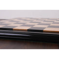 Low-angle shot focusing on the height of the raised tiles on the luxury Ebony and Maple wood chessboard.