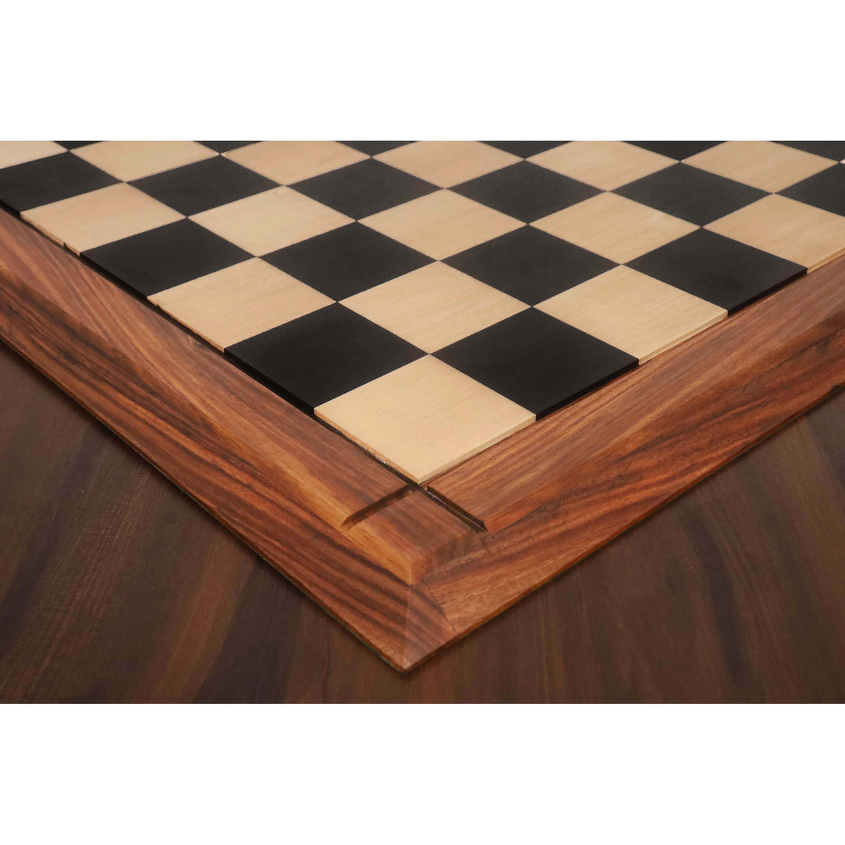 Close-up of 65 mm chess squares and grooved wood border on an ebony and maple board.