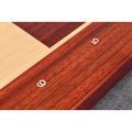 Detailed view of the natural grain of Bud Rosewood on the chessboard frame with engraved white numbers 5 and 6.