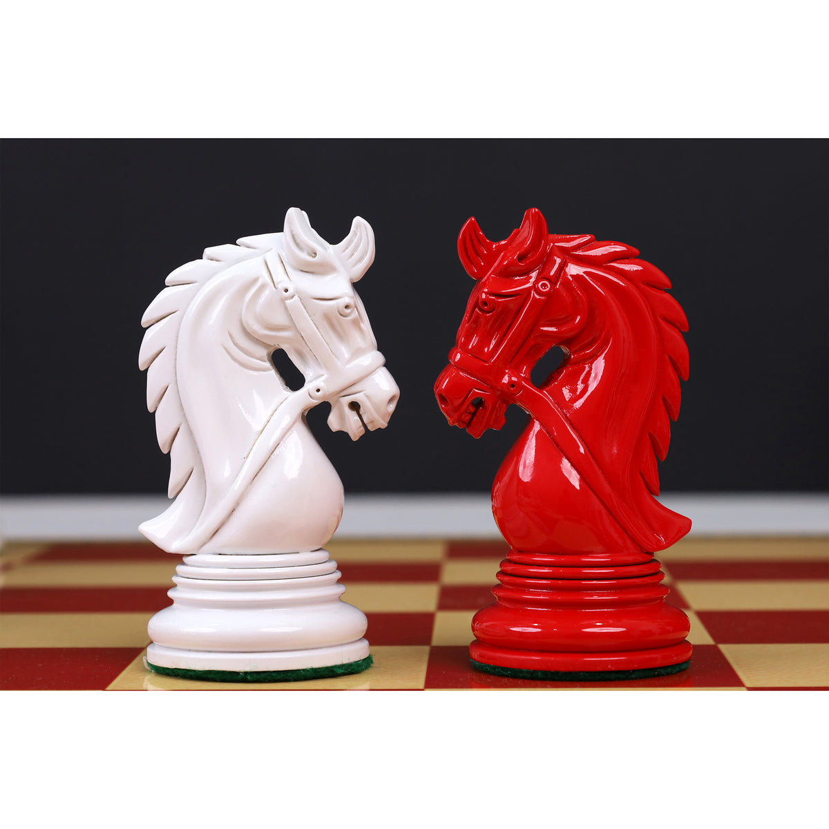 Carved details of white and red lacquered Knights from the 4.3 inch Napoleon Staunton chess set.