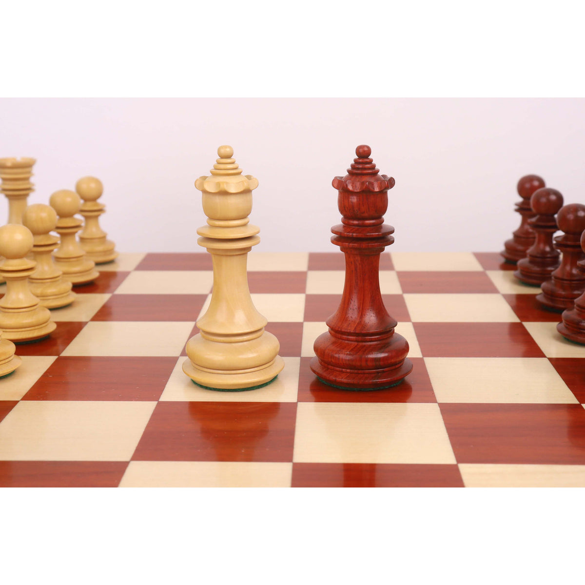 Elegant 4.5-inch Carvers' Art luxury chess queens in budrose and boxwood.