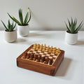 Luxury magnetic travel chess set made of golden rosewood displayed on a table.