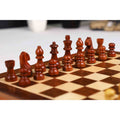 Dark wooden chess pieces arranged on a professional travel-sized magnetic board.