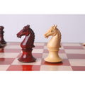 Side view of bud rosewood and boxwood knight chess pieces.