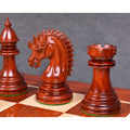 A detailed shot of the dark Bud Rosewood Dragon Knight and Rook on a wooden chessboard.