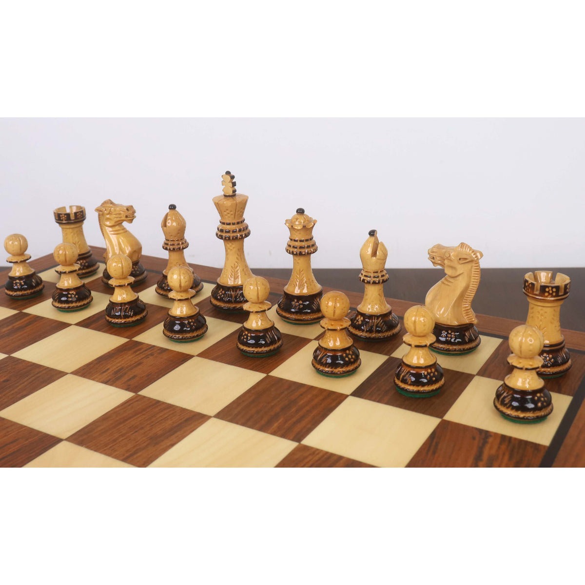 Professional light-colored Staunton chess pieces with elegant hand-carved detailing.
